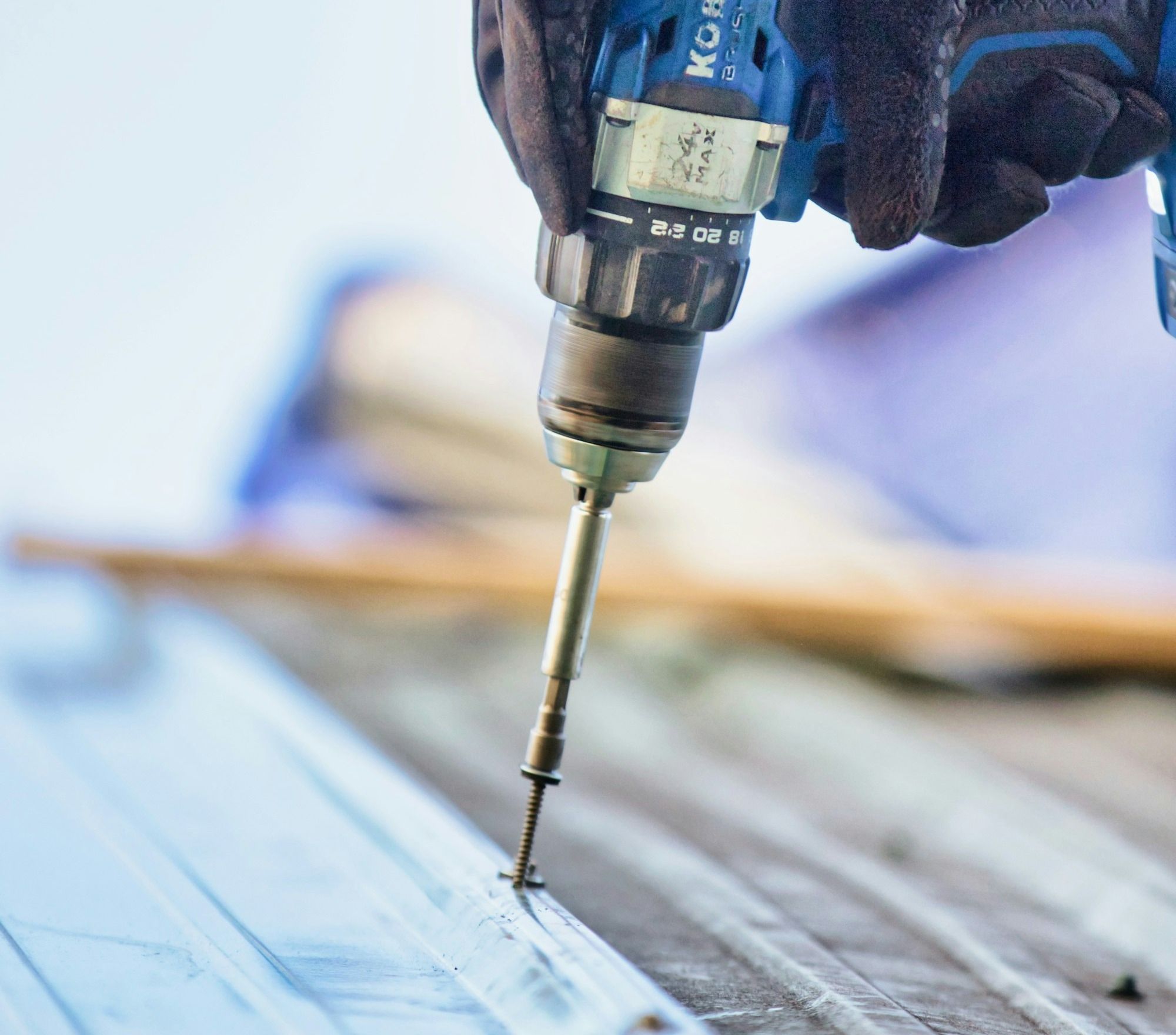 a person using a drill to drill a piece of wood