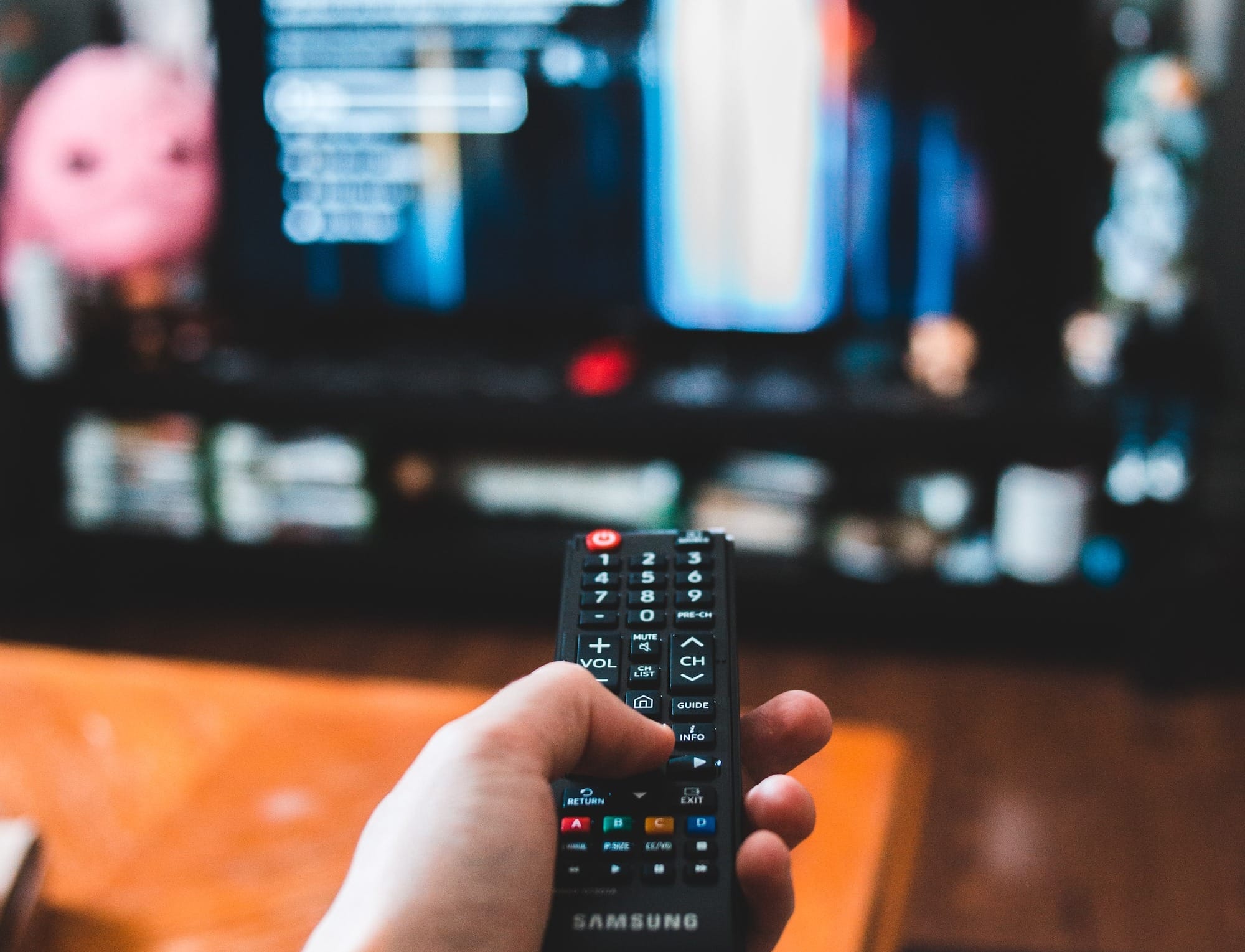 person holding black remote control