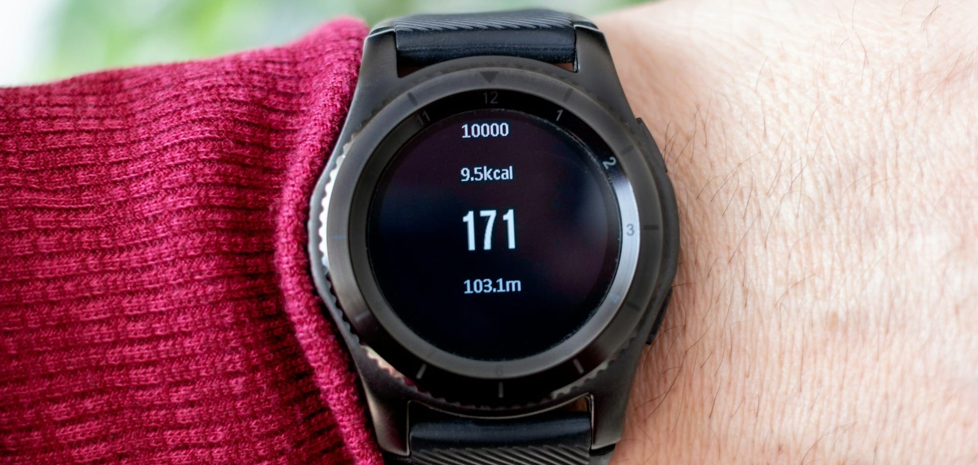 person wearing round black smartwatch