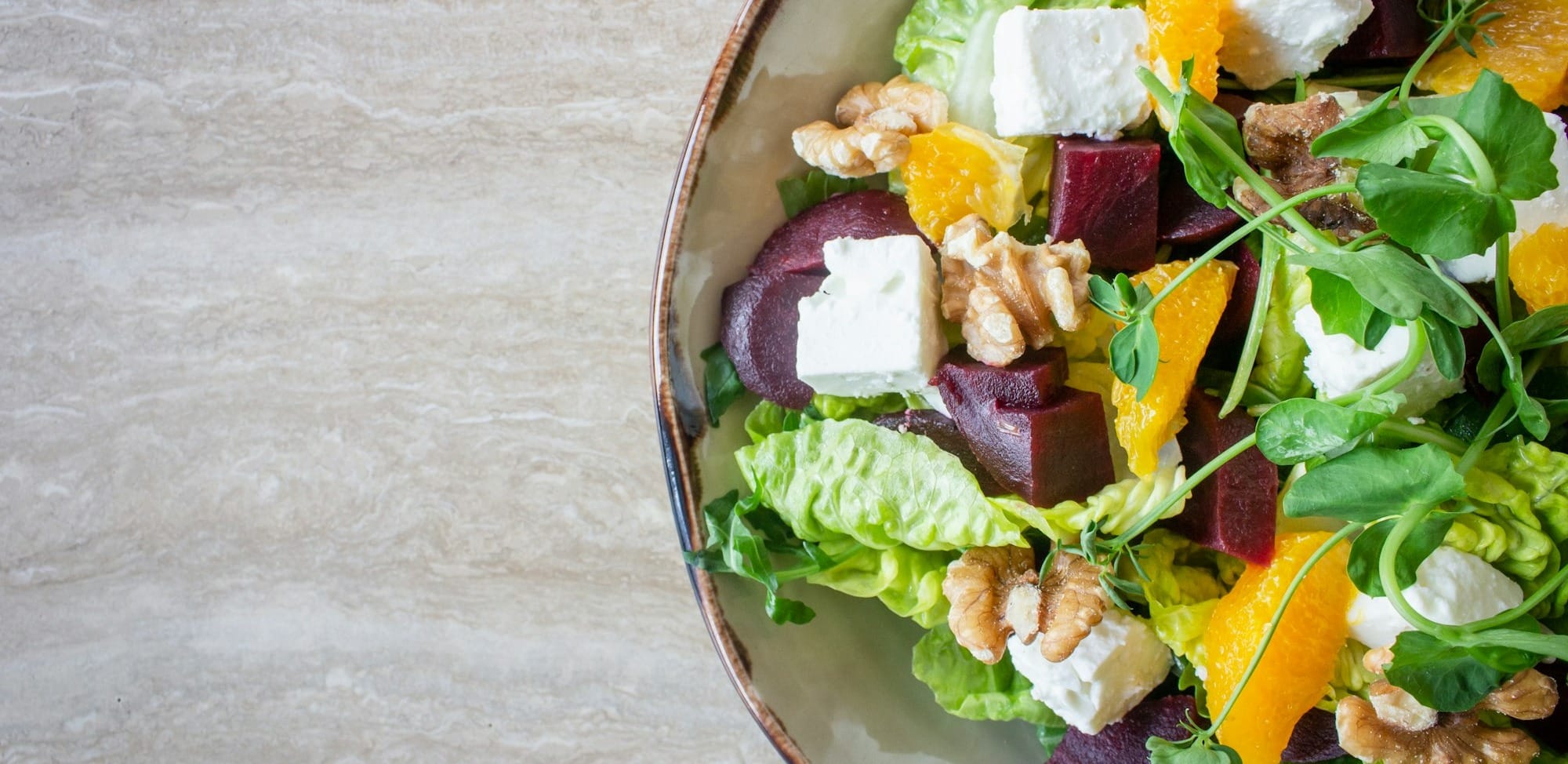 bowl of vegetable salad with walnuts