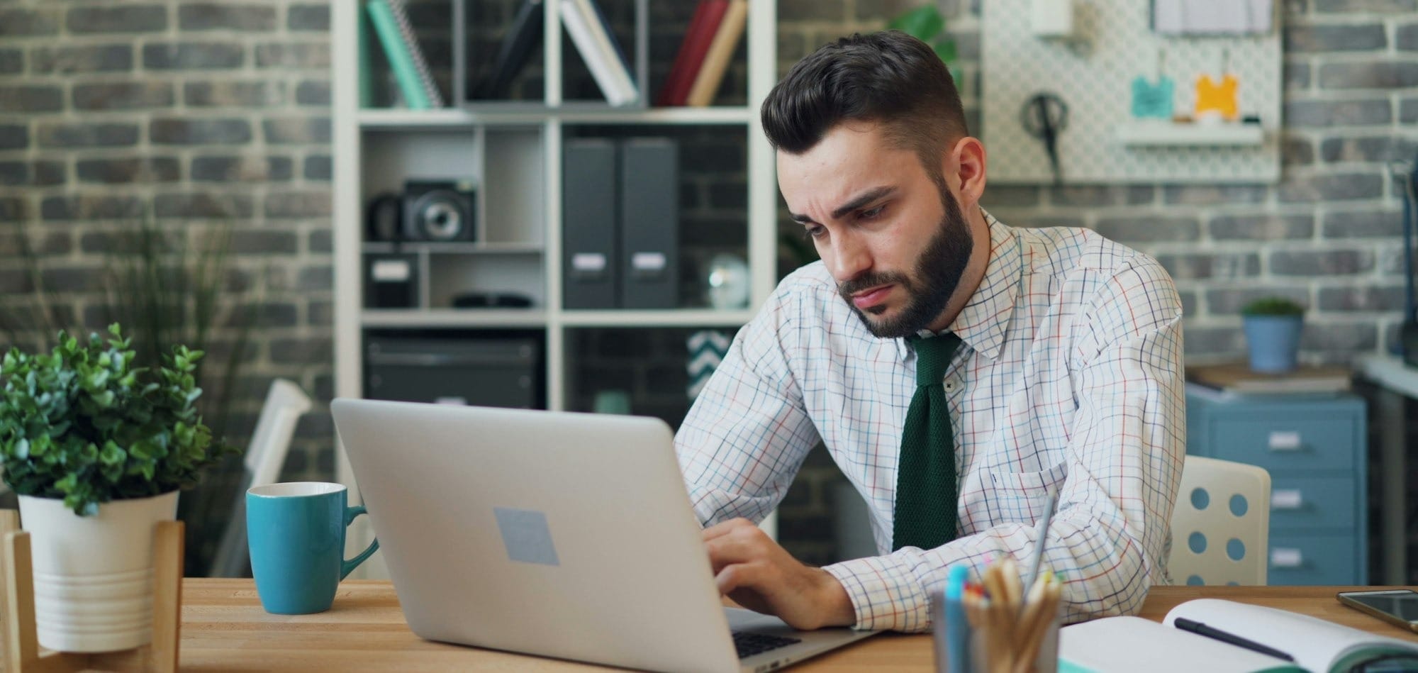 a man sitting in front of a laptop computer