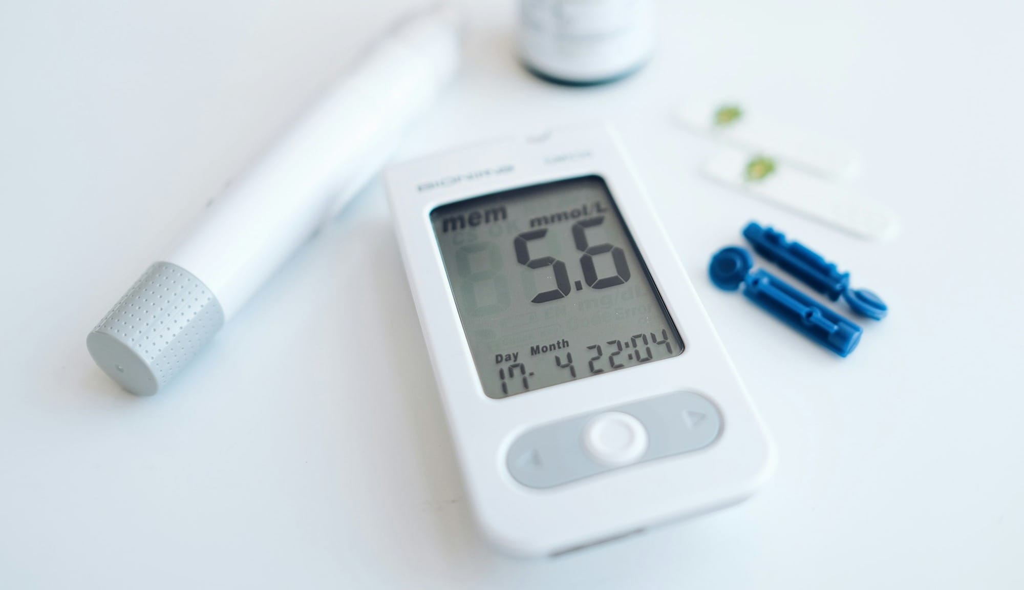 a digital thermometer sitting next to a pill bottle