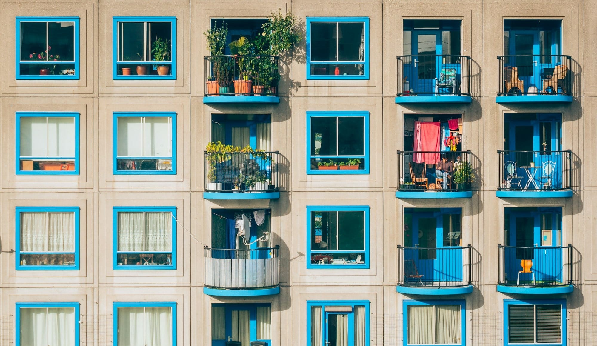 white and blue concrete 4-storey building