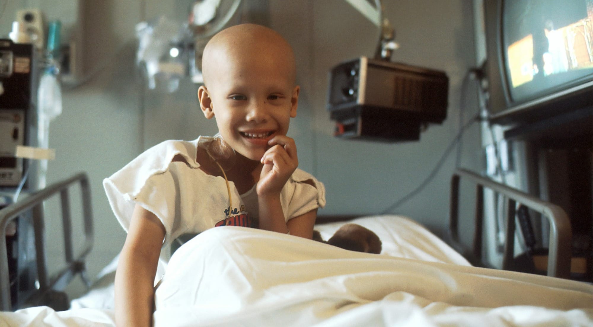 child sitting on bed