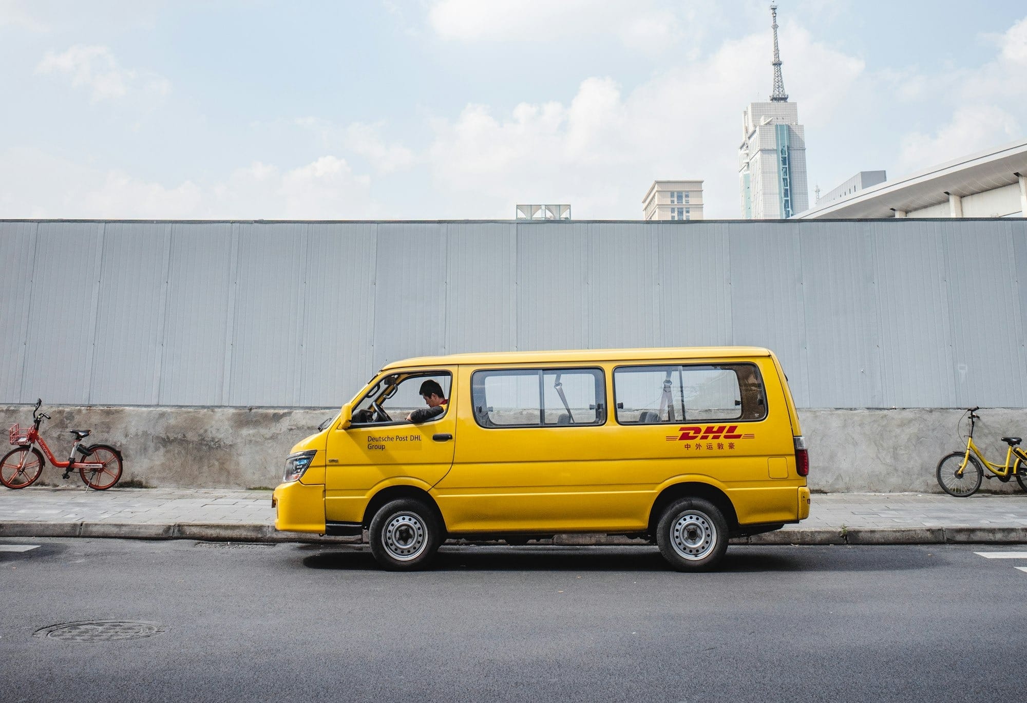 yellow car parked near white building