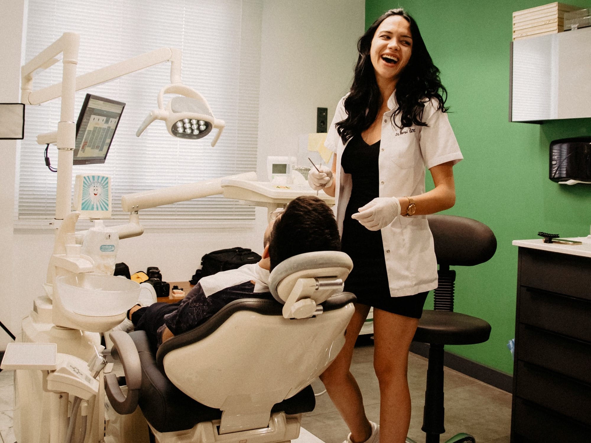 a woman standing next to a person in a hospital bed