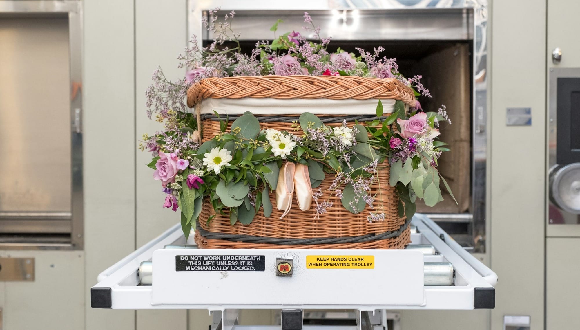 a basket filled with flowers sitting on top of a conveyor belt