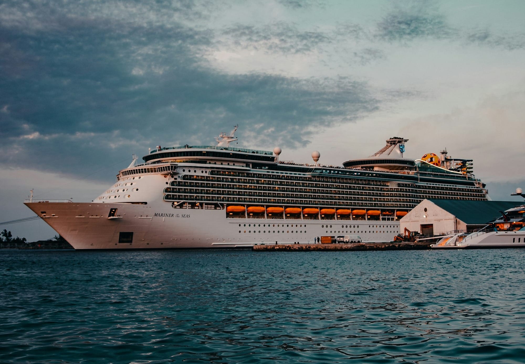 white cruise ship on sea under white clouds and blue sky during daytime